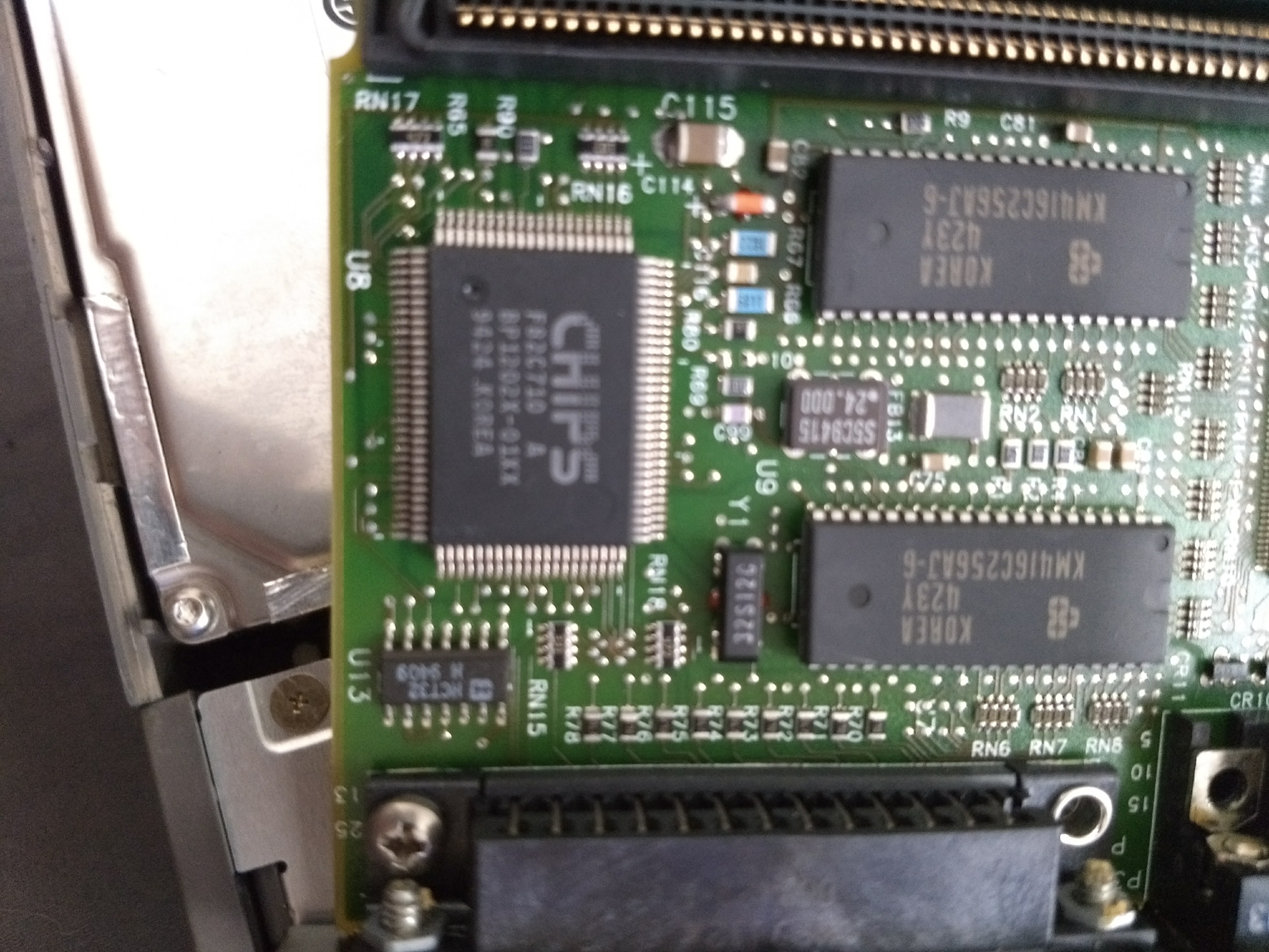 A close view of integrated circuits soldered onto a motherboard. The largest among them has the word CHIPS emblazoned on it in an 90s OutRunner-style font.