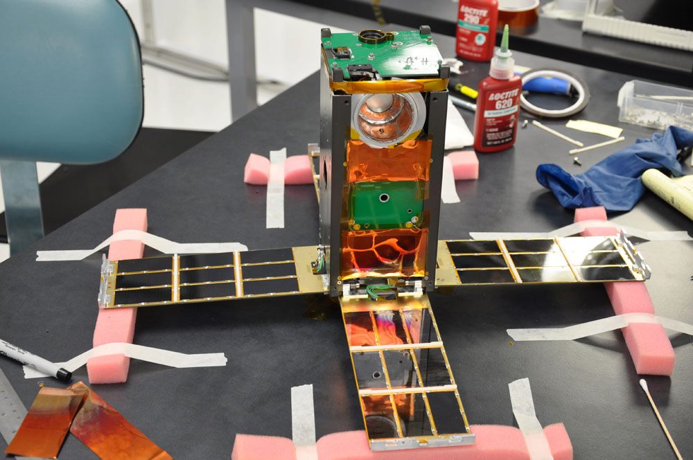 A small engineering model of a satellite, posed to look like a finished product.